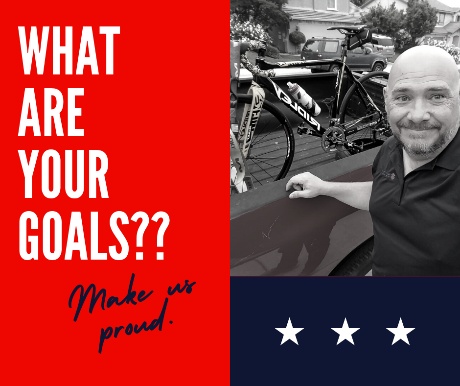 A man smiles beside a bicycle in the back of a truck, with bold motivational text asking about goals on one side and a star design on the other.